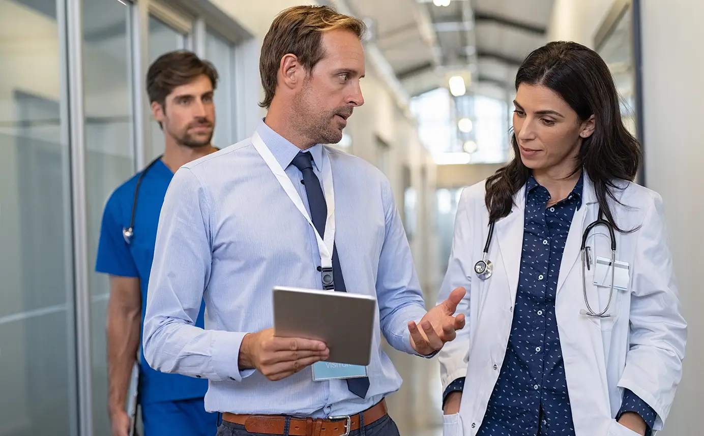 A medical team converses in a hospital hallway, providing guidance and support in a healthcare environment.