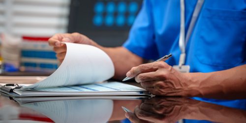 Healthcare professional reviewing patient documentation.